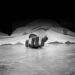 The dead man's body. Focus on hand